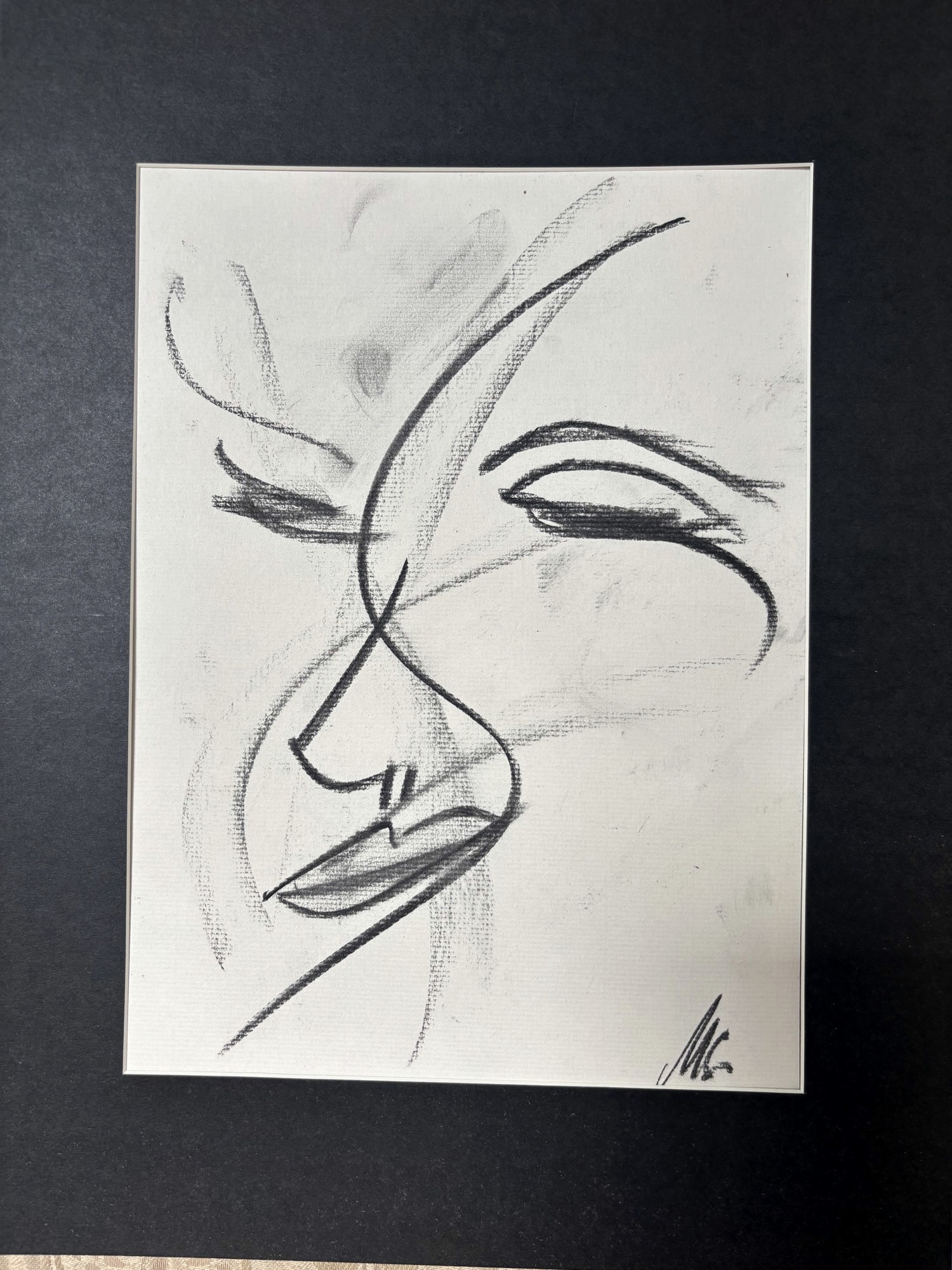 Original charcoal drawing by Martina Sachs — a face in three-quarter view, eyes lowered